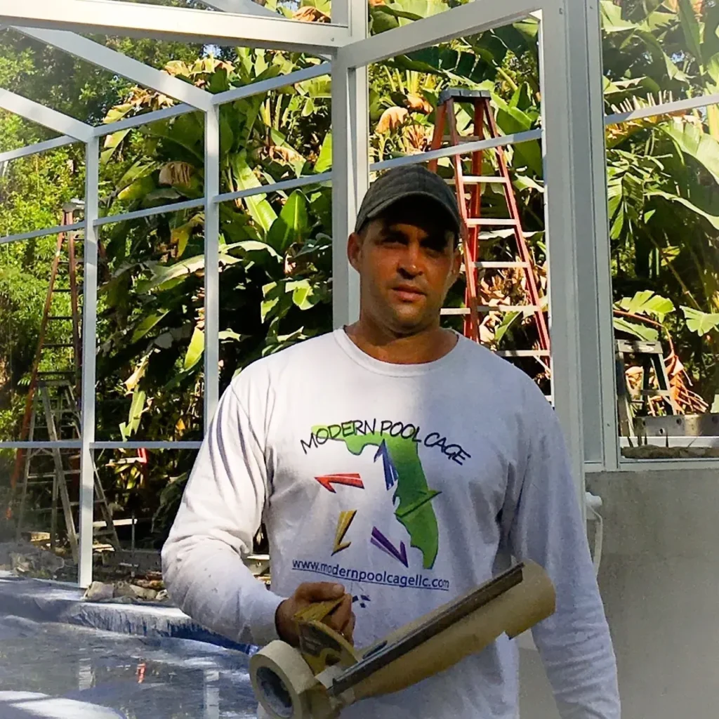 Modern Pool Cage Painting worker holding tools near pool