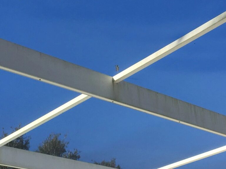 Metal beams against clear blue sky