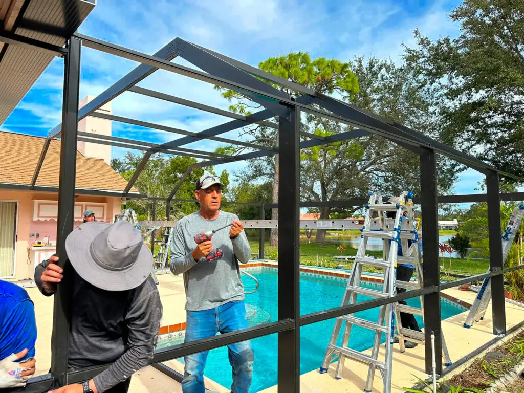 Workers of Modern Pool cage Painting repairing a Pool Cage