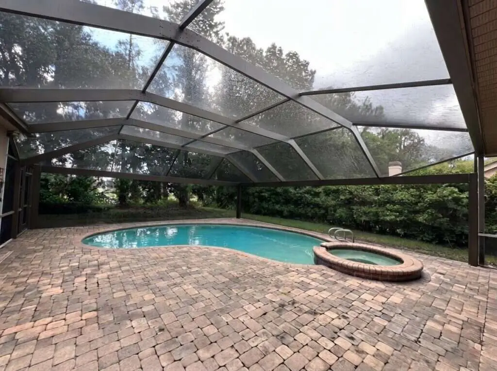 Black aluminum pool cage freshly painted and rescreened with a new panoramic picture-window screen (clear view)