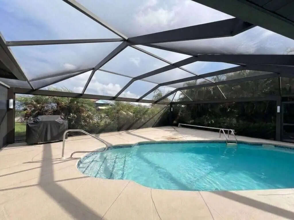 Black aluminum pool cage freshly painted and rescreened with a new panoramic picture-window screen (clear view)