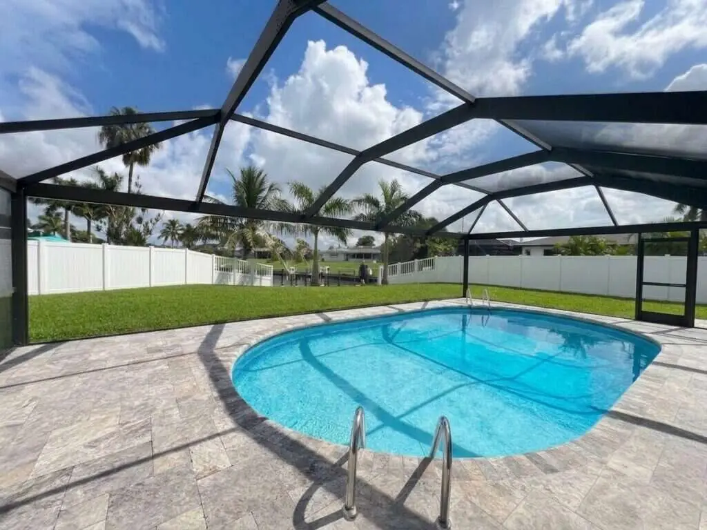 Black aluminum pool cage freshly painted and rescreened with a new panoramic picture-window screen (clear view)