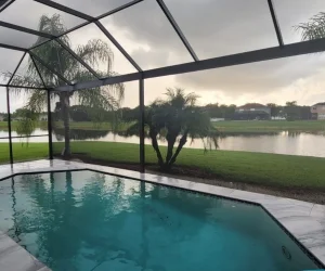 Clear View Screen Enclosures near a calm lake scene