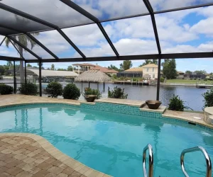 Backyard pool facing a scenic waterway and a Clear View Screen