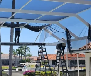 Modern Pool cage Painting worker assembling screen in patio enclosure